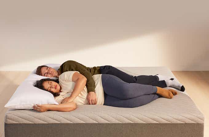 Couple sleeping on Casper Wave mattress