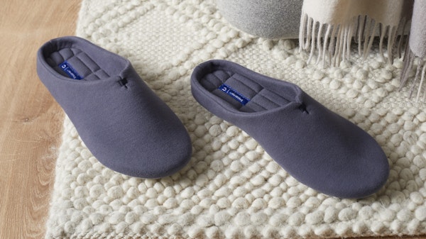 Indigo Snoozewear Slippers on a rug