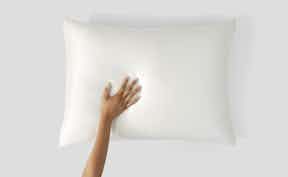 Hand on oatmilk silk pillowcase
