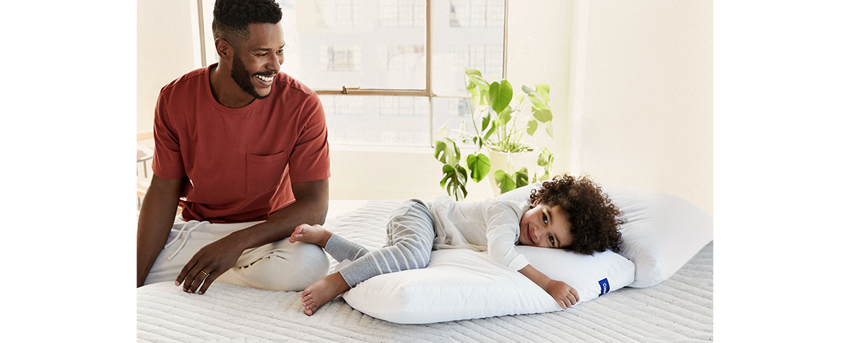 Two Casper employees holding a piece of mattress foam.
