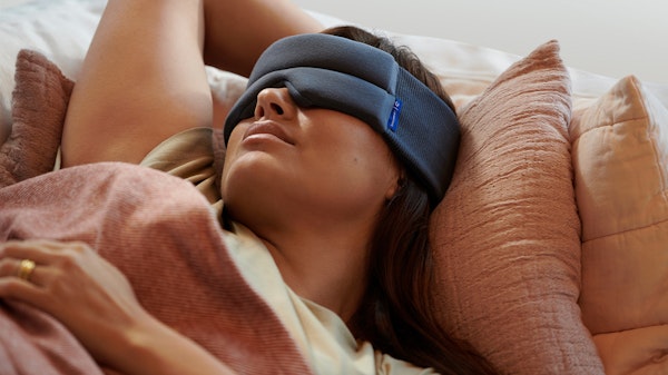 Woman sleep with Snoozewear Sleep Mask in indigo