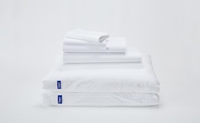 Sheet set stacked on top of 2 pillows