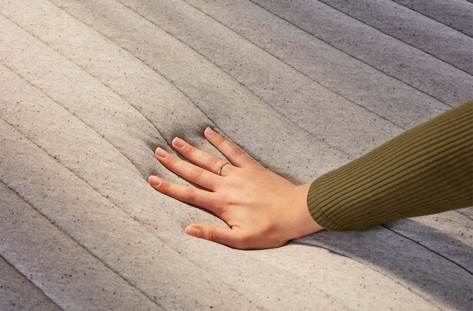 Hand touching Casper Wave mattress