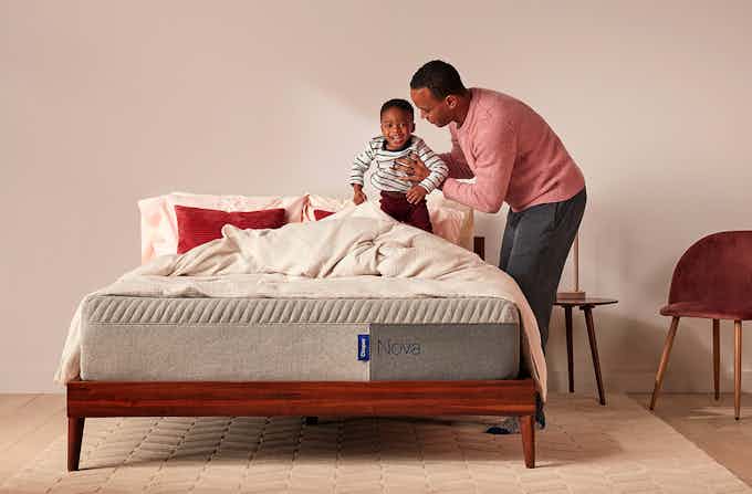 Father helping son on Casper Nova Foam mattress