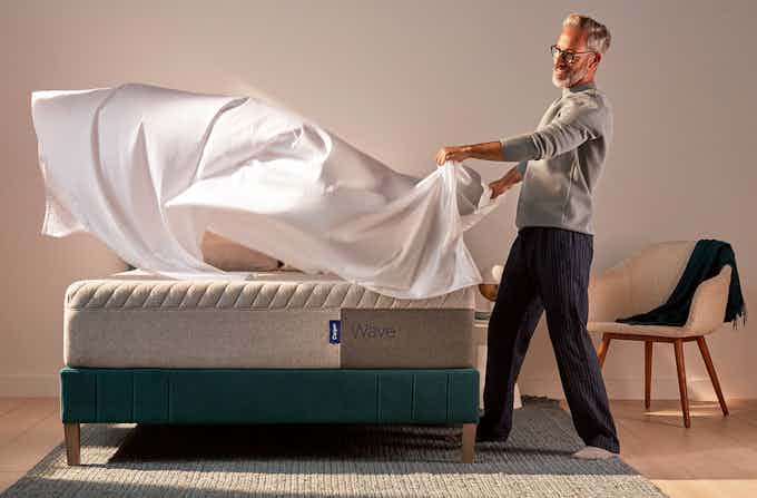 Man putting sheets on a Casper Wave mattress